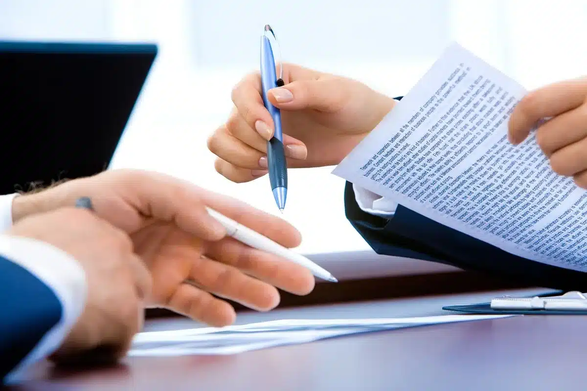 Blurred team logos and roster documents on a desk during NBA offseason planning
