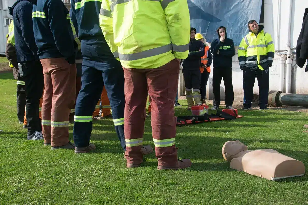 Rescuer performing emergency CPR on a sea otter pup at a marina dock with concerned onlookers nearby