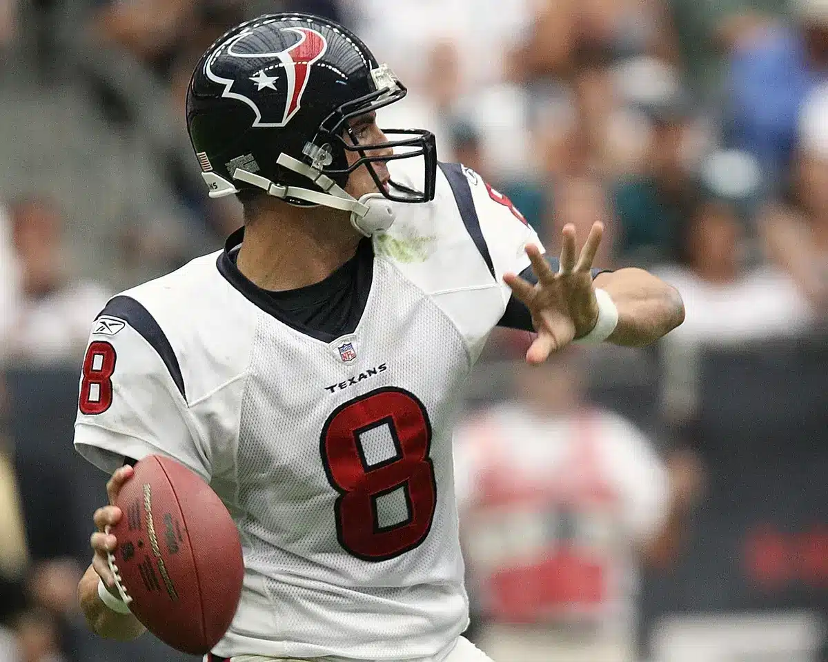 Quarterback in mid-throw during a college football game