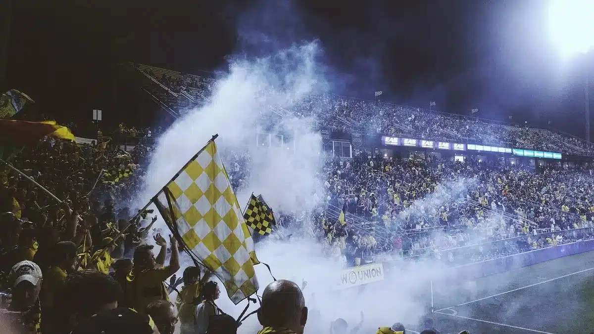 Crowd of disappointed fans in stadium seats during preseason game