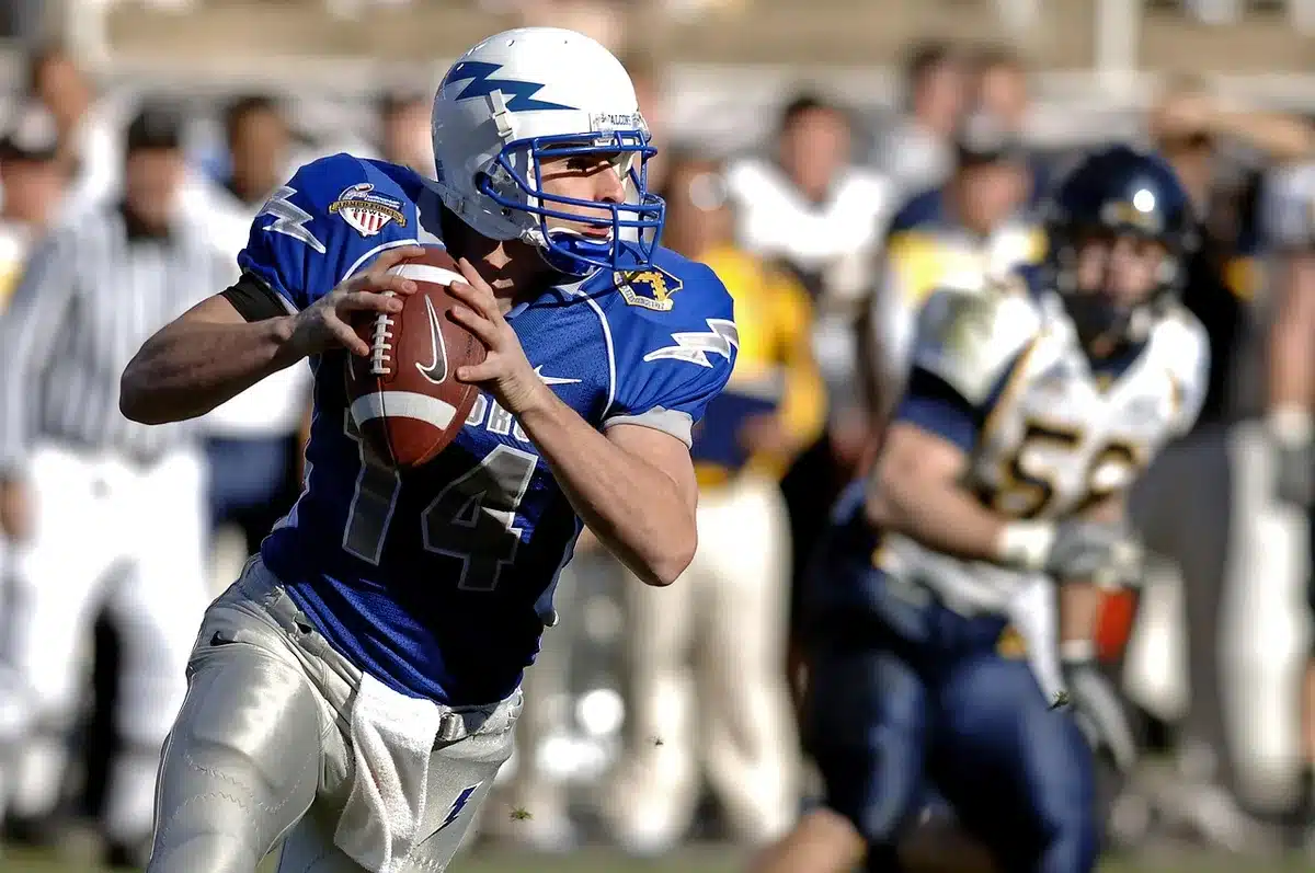 Multiple quarterbacks competing in practice drills during NFL training camp