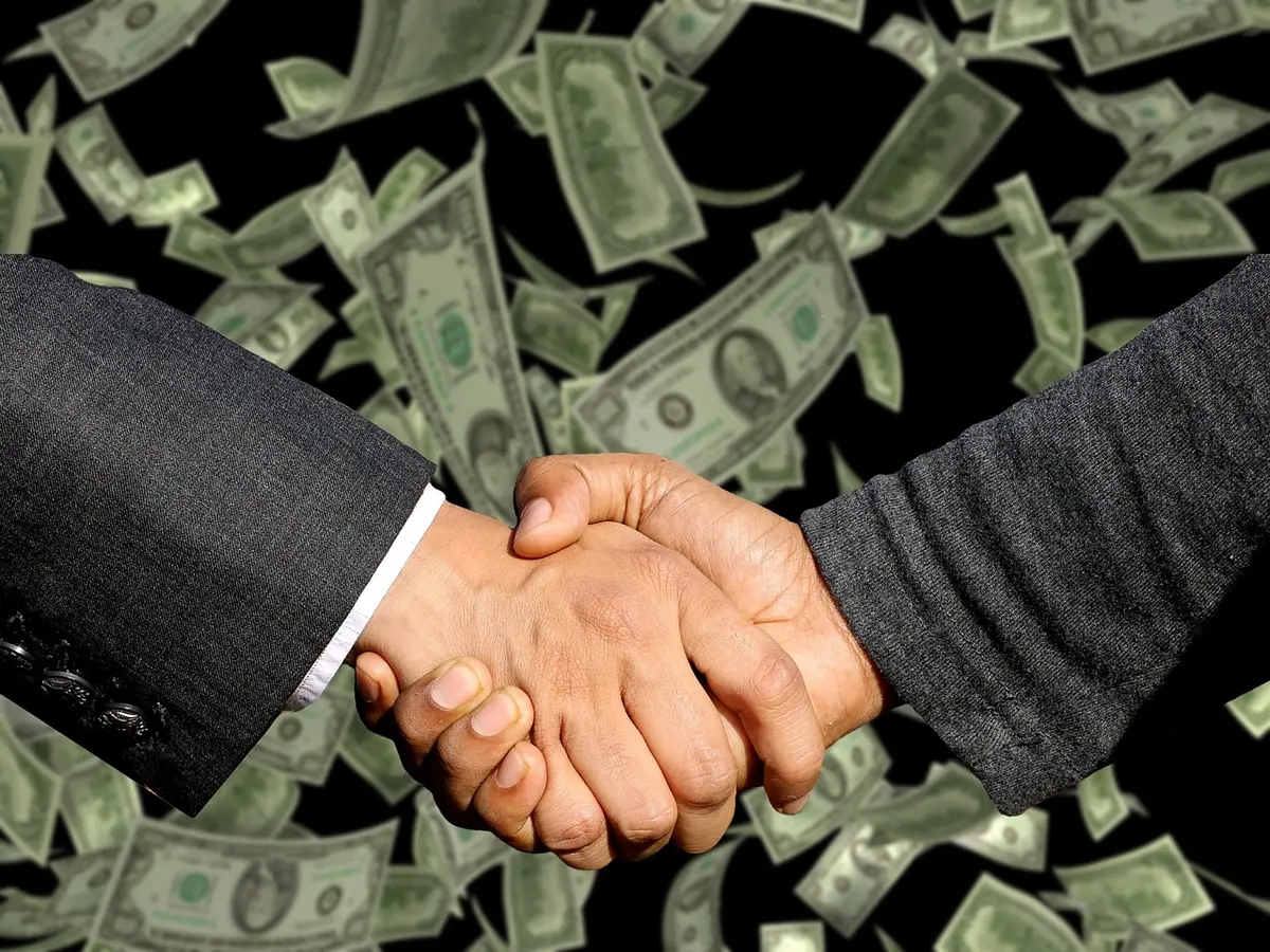 Salary cap spreadsheet and contract negotiations document on desk