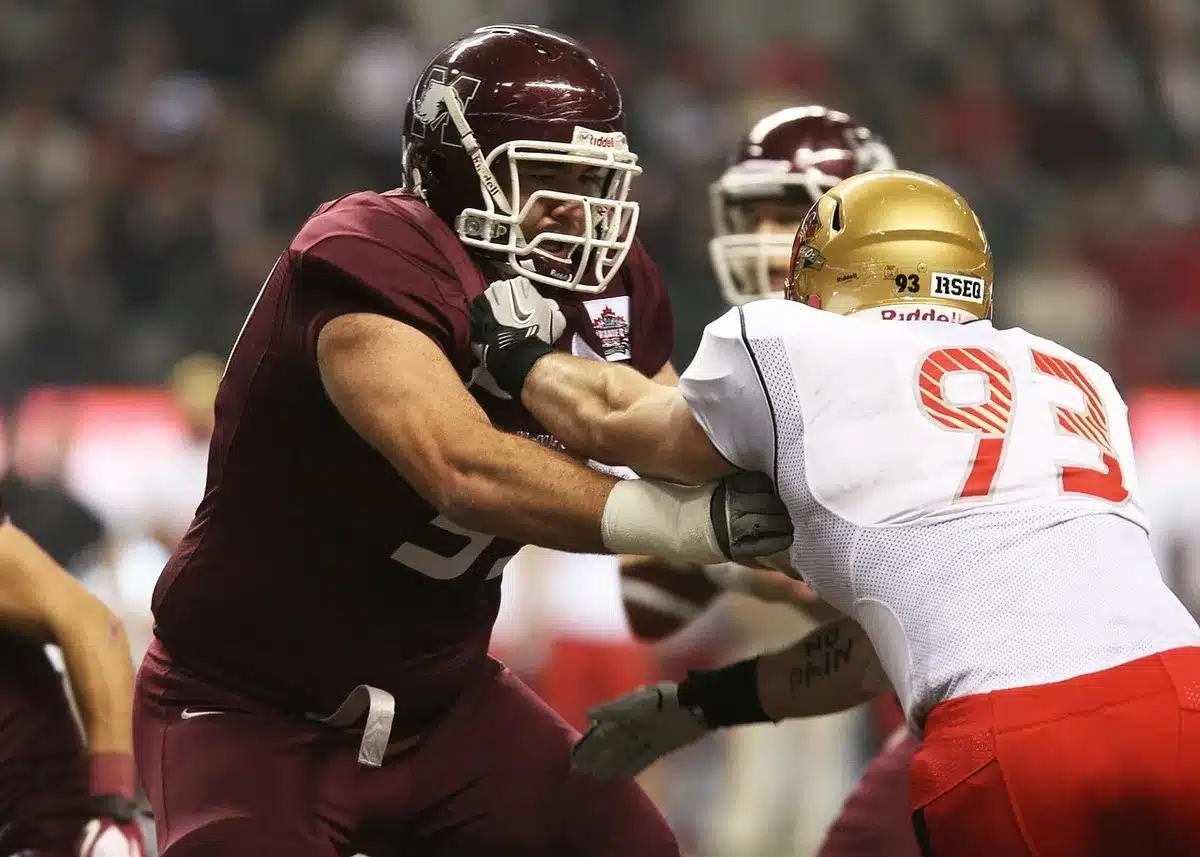 Offensive linemen working together to protect the quarterback during a play