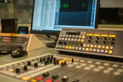 Backlit podcast microphone and silhouette in a studio control room