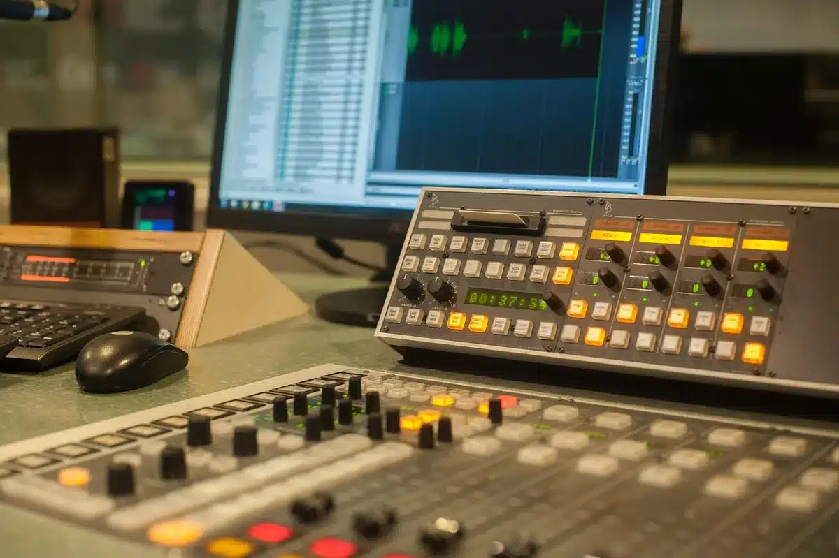 Backlit podcast microphone and silhouette in a studio control room