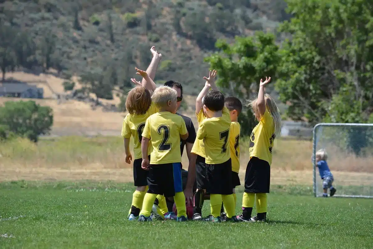 Blocked field-goal play with players reacting on the field
