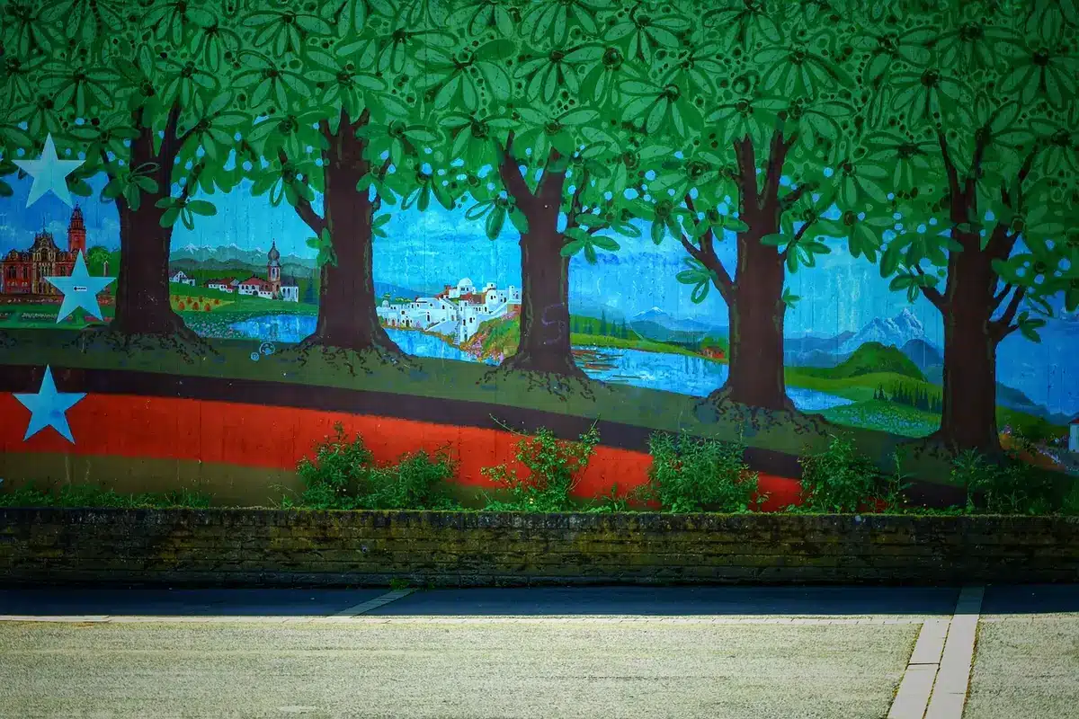 Conservator examining a large mural up close with lighting and lift