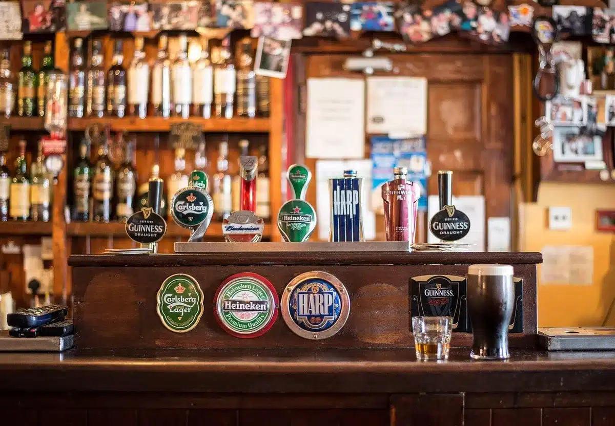 Interior of a traditional village pub with wooden bar and community noticeboard