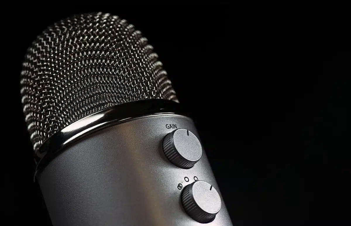 Hosts in a roundtable podcast discussion in a studio