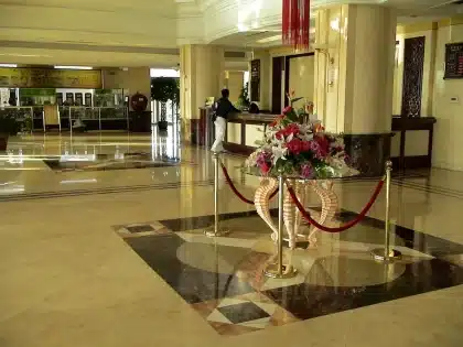 Empty hotel reception with luggage carts and unassigned room keys on desk