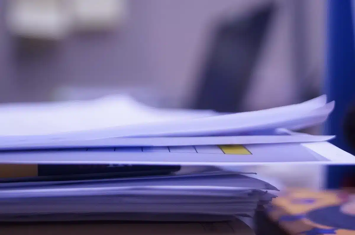 Close-up of recruitment paperwork and academic CVs on a desk