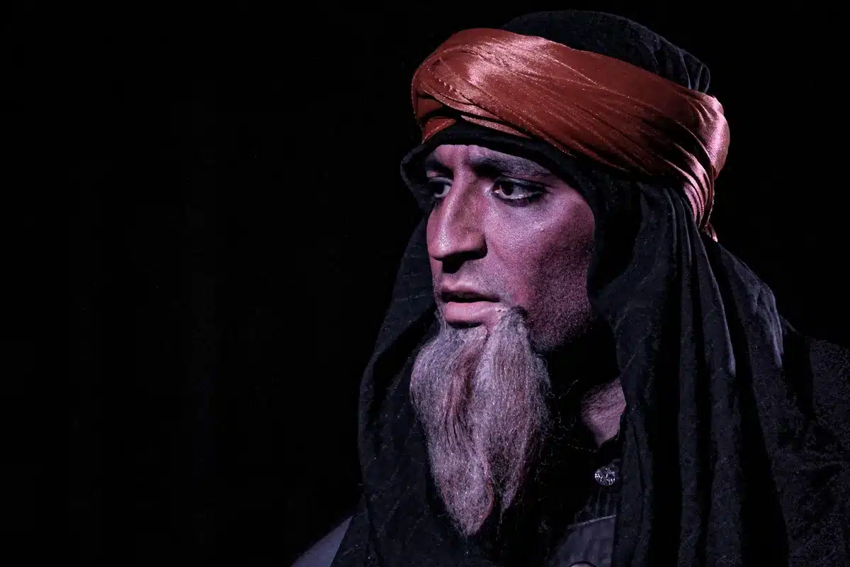 Close-up of an actor's hands and face in a thoughtful performance